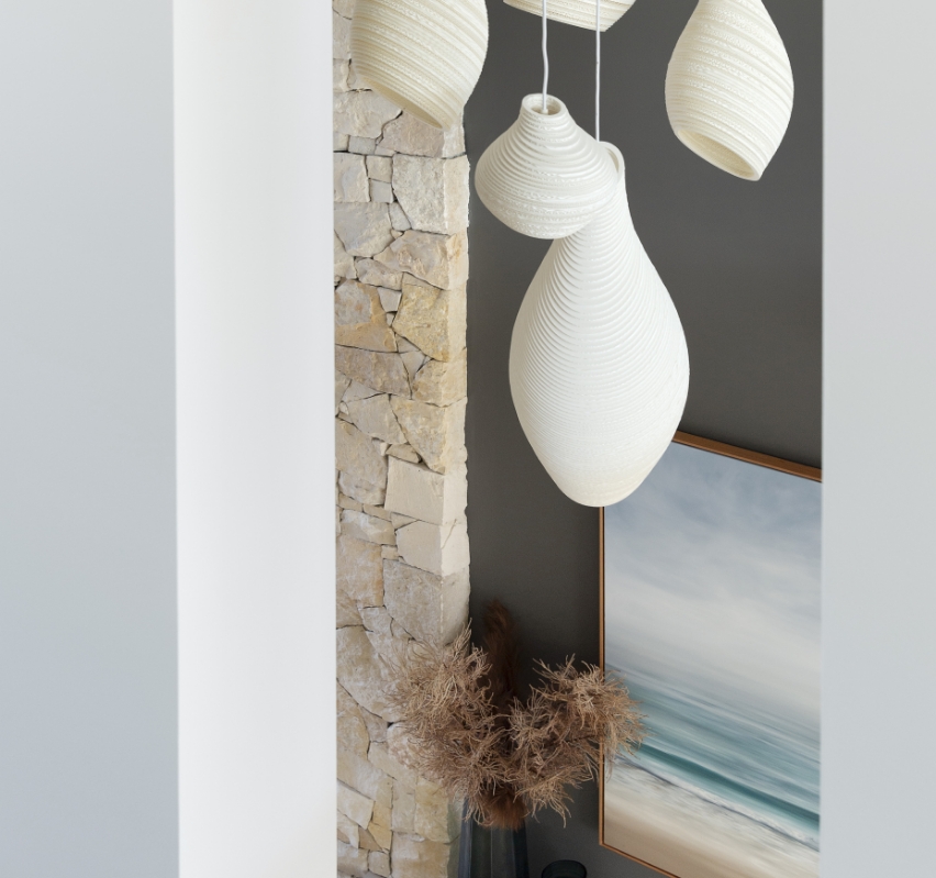 Modern interior with pendant lights and decorative stone wall.
