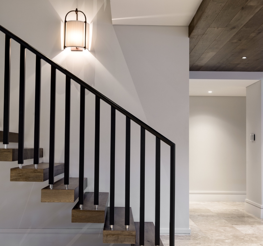 Modern staircase with wooden steps and metal railing
