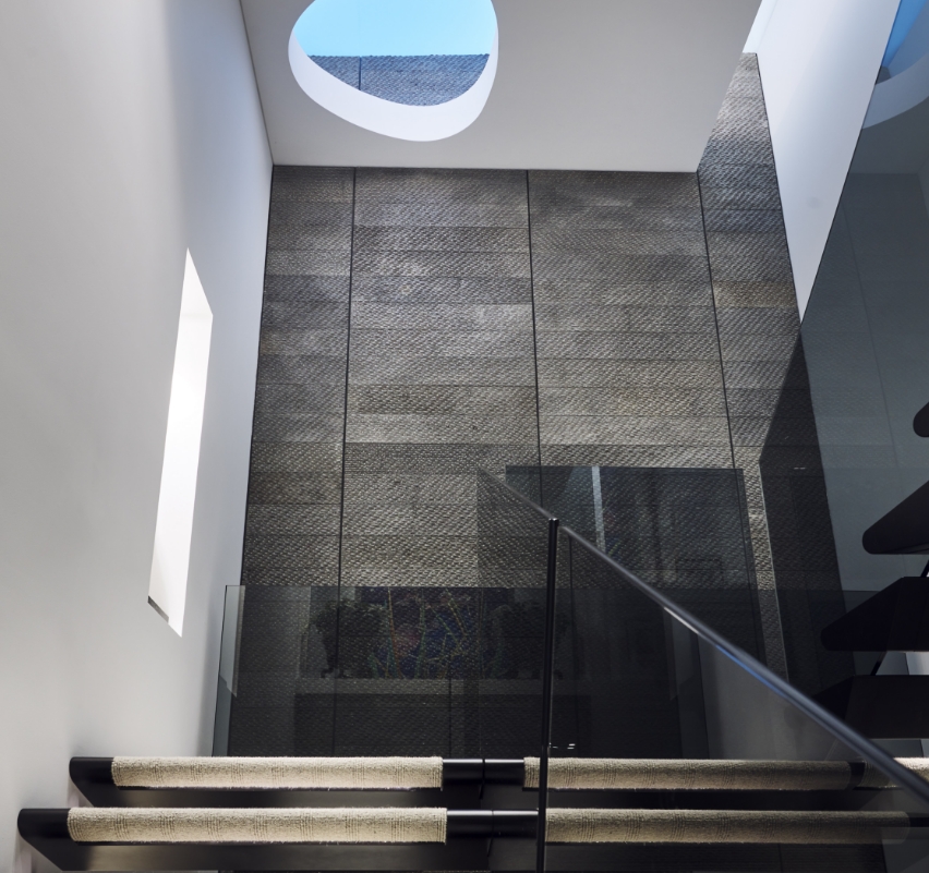 Modern staircase with unique oval skylight.