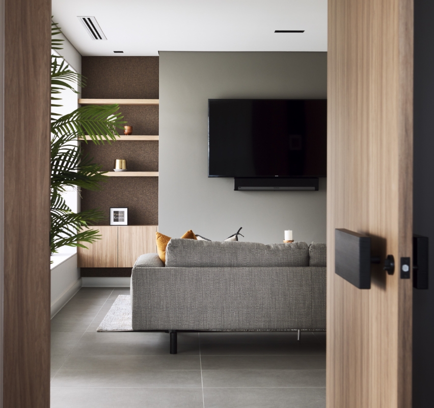 Modern living room with sofa and wall-mounted TV.