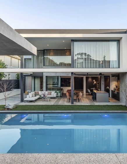 Modern house with pool at dusk.